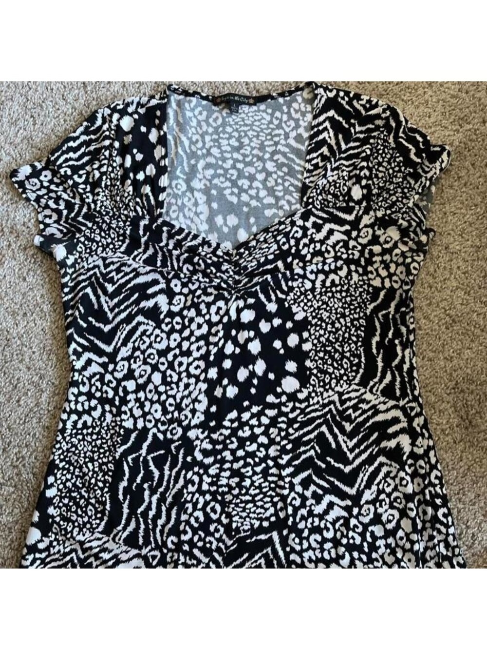 white and black animal print blouse with leopard, zebra, and chevron patterns